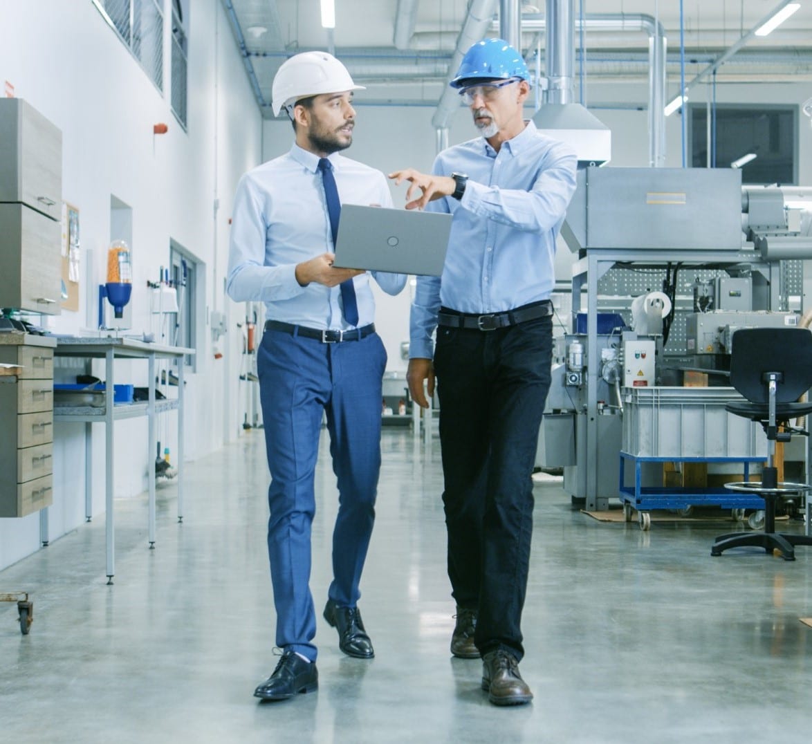 Back View of the Head of the Project Holds Laptop and Discussing